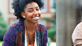 Student posed in front of a campus building.